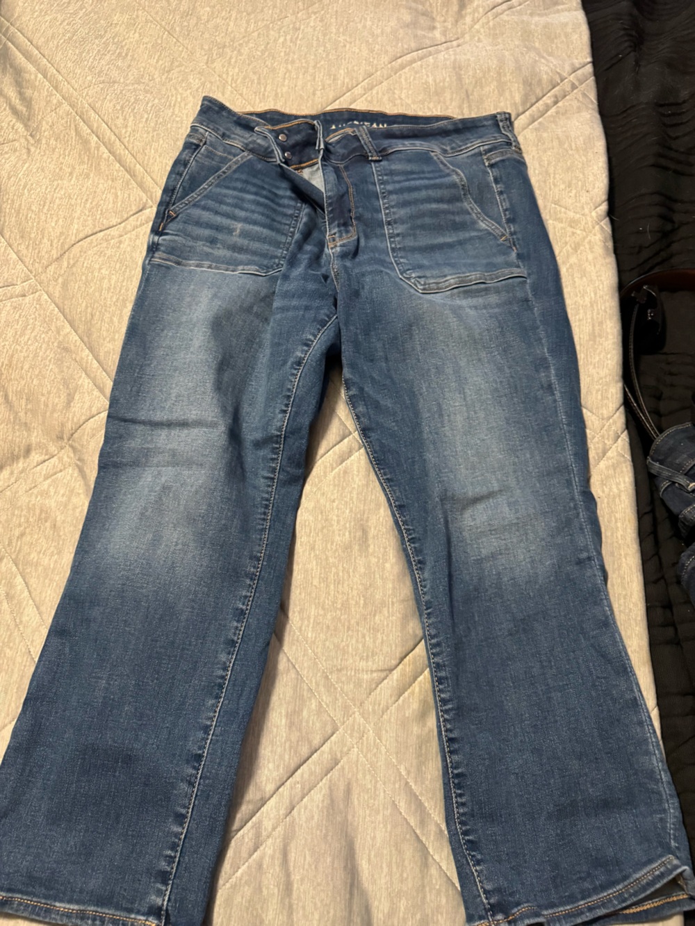 American Eagle Outfitters light blue denim jeans with gold stitching